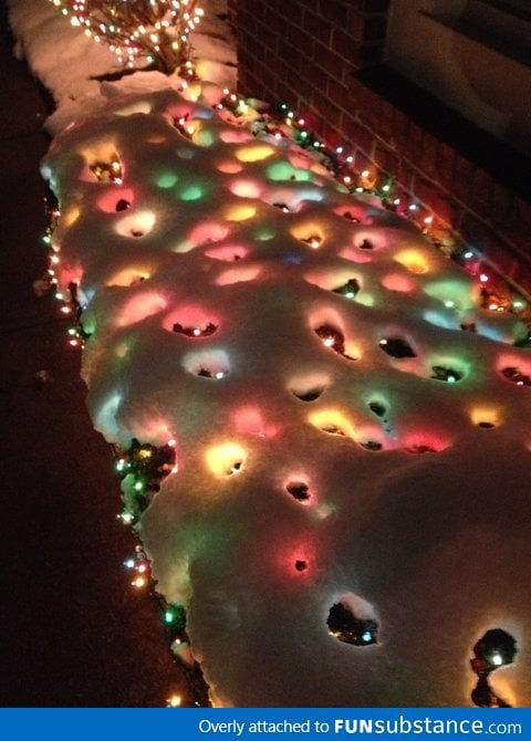 Christmas lights melted holes in the snow. Looks cool