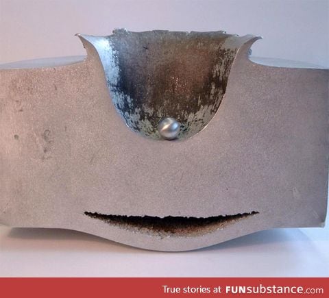 Result of a steel ball, moving at 4.2 miles/second, impacting a 12 inch thick steel block