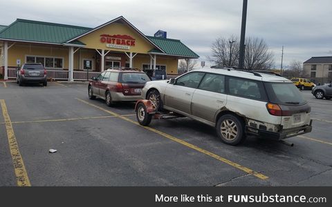 An Outback pulling an Outback, stopped to eat at Outback, parked outback