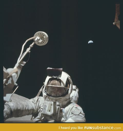 Astronaut on the moon with the Earth in the distance