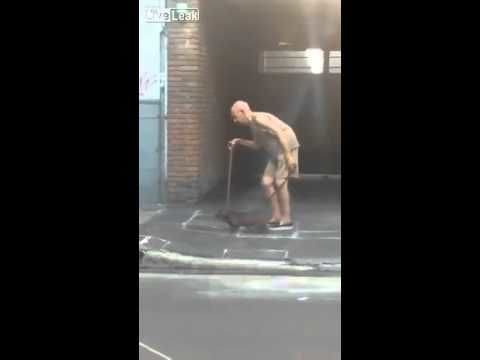 Patient dog walks very slowly so old man can keep up