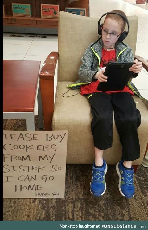 A brother helps his sister sell Girl Scout cookies.