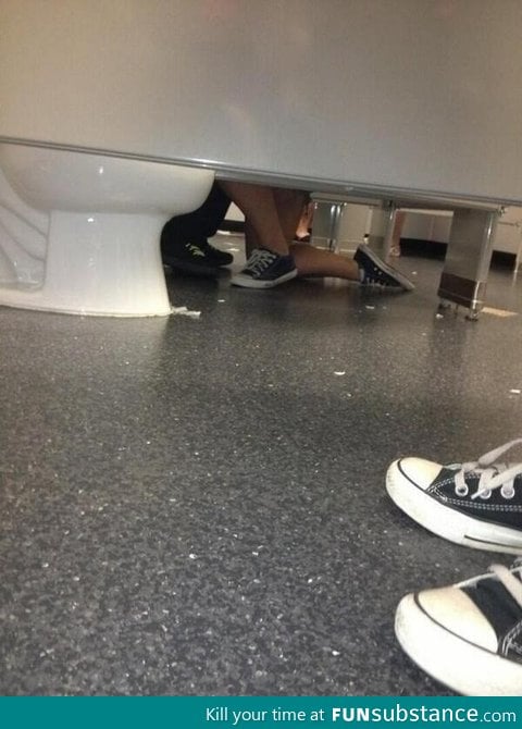 Aww, there's a girl proposing to a guy in the bathroom!