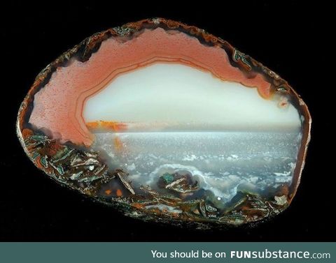 Cross section of agate mineral - looks like an ocean landscape