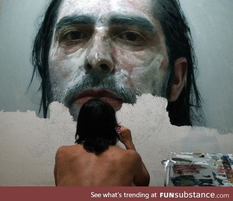 Artist paints photorealistic portrait of himself covered in paint