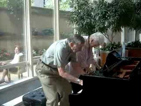 90 year old couple play an impromptu piano duet in the Mayo Clinic lobby