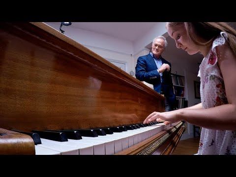 Girl performs an improvised piece on the piano using four randomly picked notes