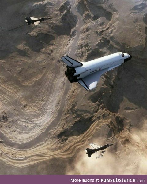 Space shuttle escorted by fighter jets