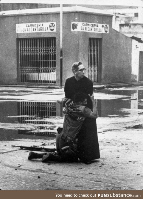 A priest consoling a dying soldier ad they are surrounded by snipers. Venezuela 1962