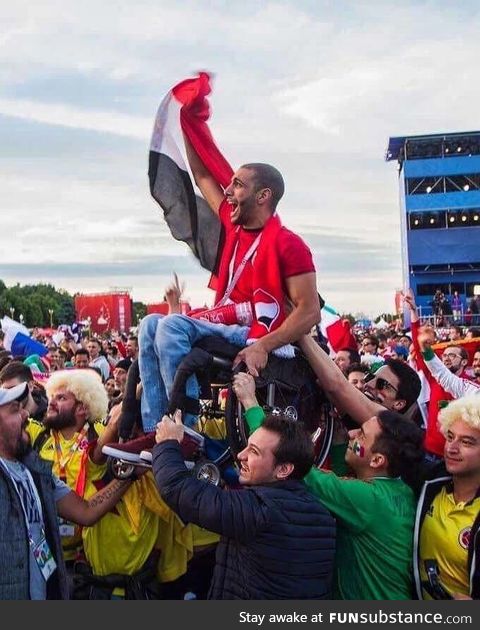 Egyptian fan lifted by Mexican and Colombian fans so he could see his team play