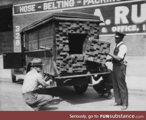 [1926] Federal agents, alerted by the smell of alcohol, inspecting a "lumber truck"