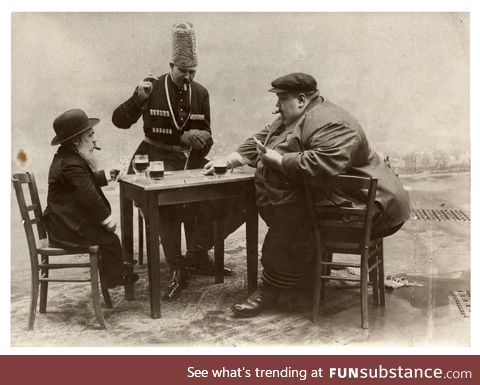 The shortest, tallest, and fattest men of Europe drinking and playing cards together 1913