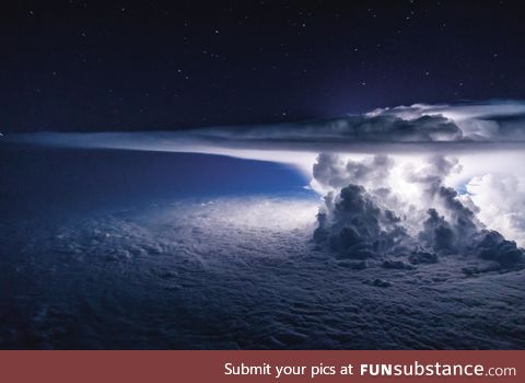 Thunderstorm above Pacific Ocean captured from a plane c*ckpit, by Santiago Borja