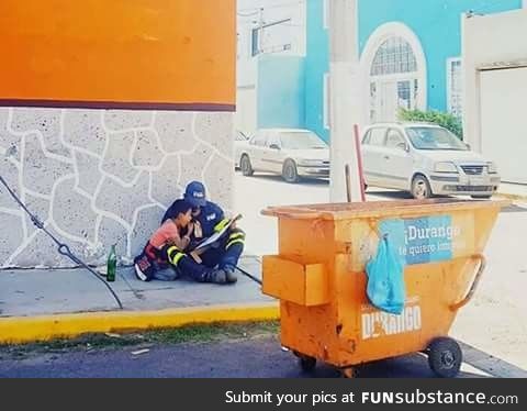 A father takes a break from his job to educate his son on the street