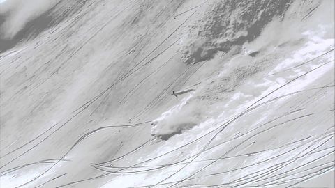 Skier outrunning an avalanche does a backflip