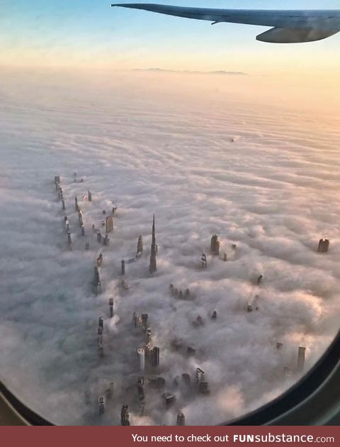 Towers of Dubai breaking through the clouds