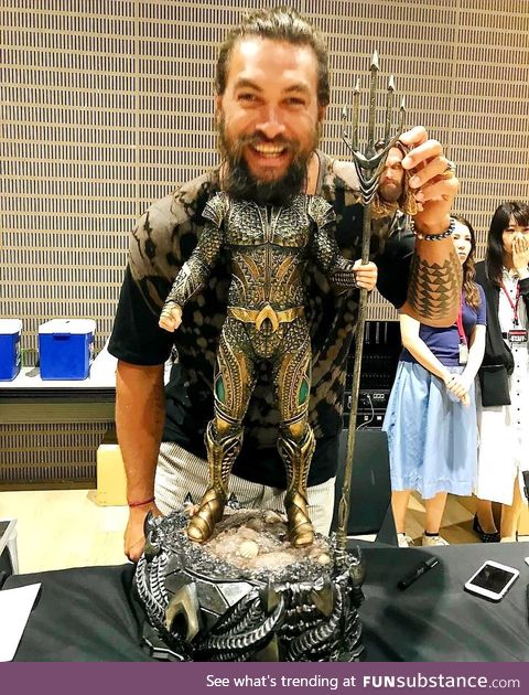 Jason Mamoa having fun with his action figure