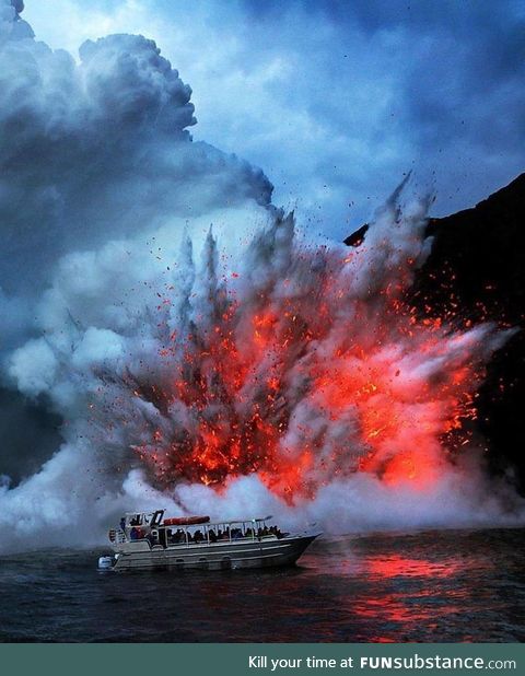 Lava exploding next to a tourist boat