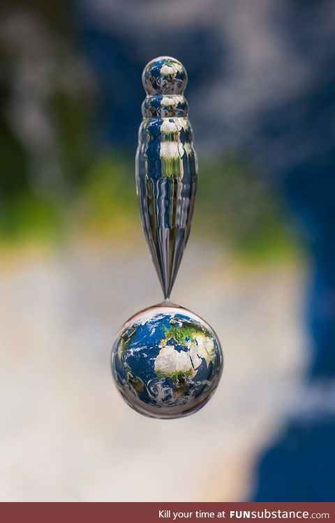 Water droplet captured above map of the earth