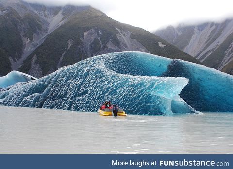 The dark blue bottom of an iceberg that just rolled over