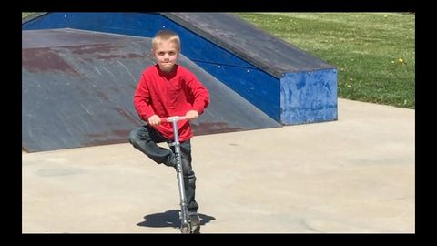 Adorable kid trying to impress some skateboarders