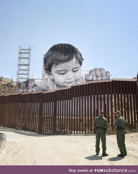 Street artist installs face of a child on Mexican side of the border wall