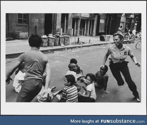 A police officer playing with children in New York, 1970