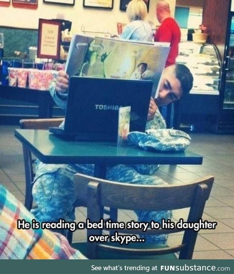 Reading his daughter a bedtime story