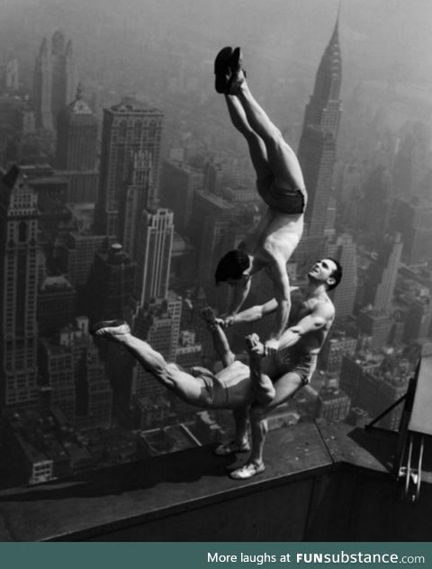 Acrobats balance at the top of Empire State Building, 1934
