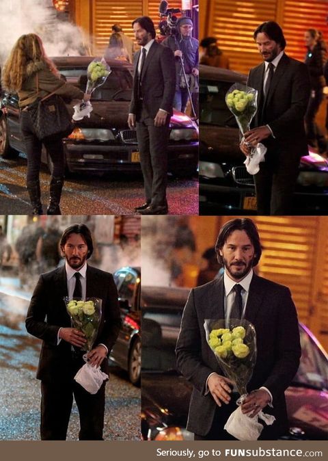 Keanu Reeves getting flowers from a fan on set of John Wick 2