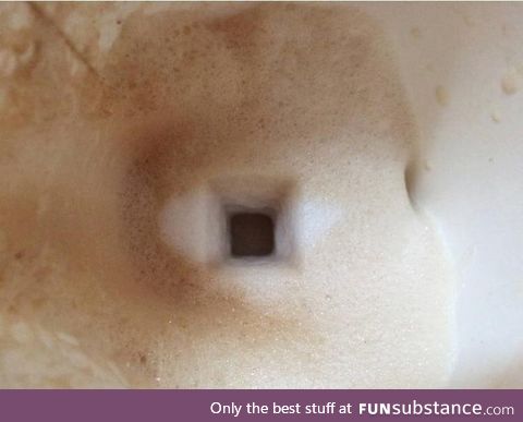 The trail of the sugar cube falling through the milk froth