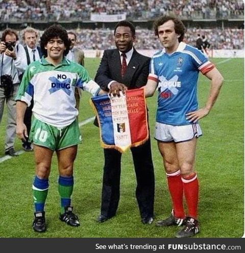 It is year 1986. Maradona is wearing "no drugs" shirt. Platini is wearing