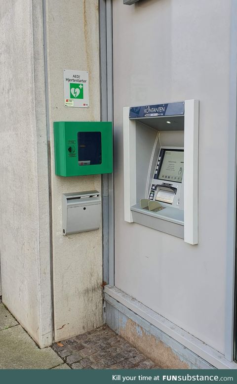 This ATM in Denmark with a defibrillator hanging right next to it, just in case you get a