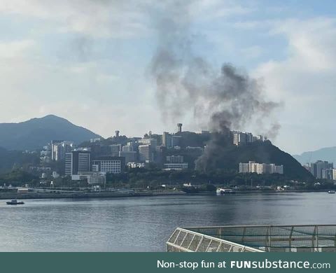 Smoke from TEAR GAS over a college campus, CUHK, in Hong Kong, where the police entered