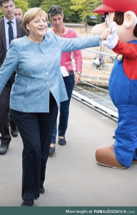 Chancellor Merkel casually high fiving Mario