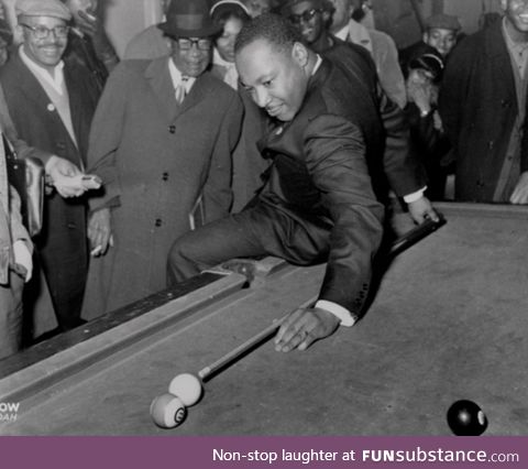 Martin Luther King Jr playing pool after a march
