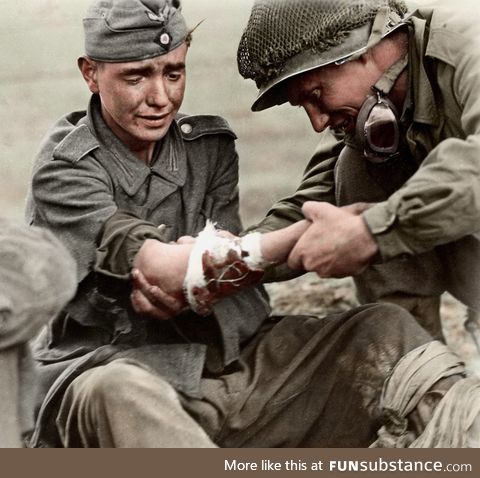 An American GI tending to a wounded young German soldier - France, Sept. 6 1944