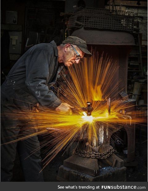 Blacksmith striking his hammer