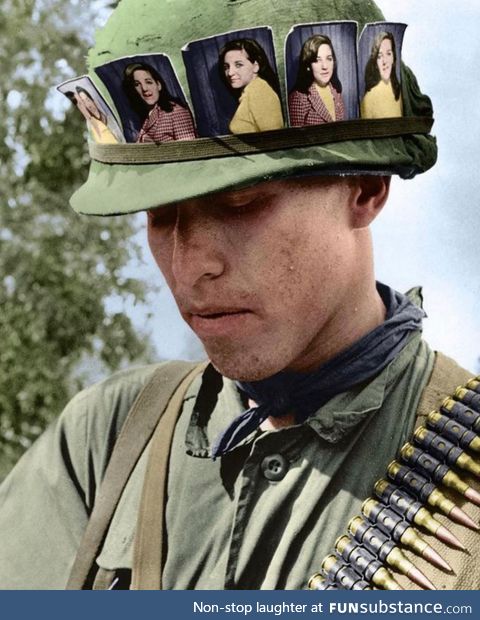 US soldier with pictures of his girlfriend, Chu Chi base camp, Vietnam 1968