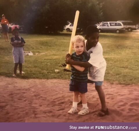 An old Polaroid of me learning how to play wiffle ball with my cousin Andre in the late