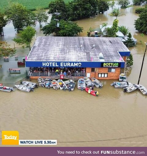 Floods in Cairns, QLD, Australia. Locals still attend the local pub in boats