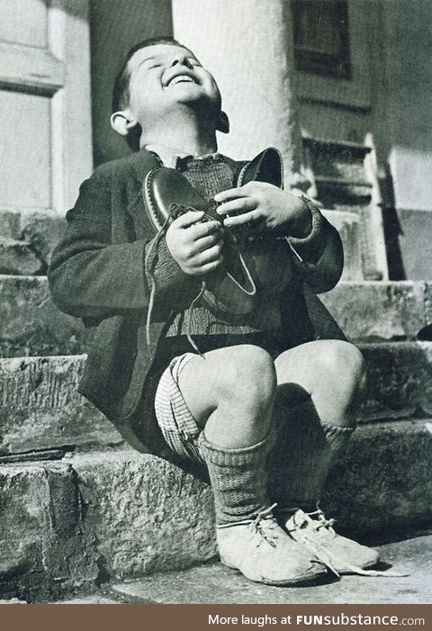 An Austrian boy receiving new shoes during WWII
