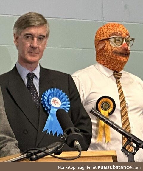 Jacob Rees-Mogg standing next to man wearing a baked beans balaclava after losing the