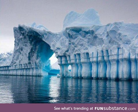 Ice formations in antarctica that look like ice walls, columns, and an archway