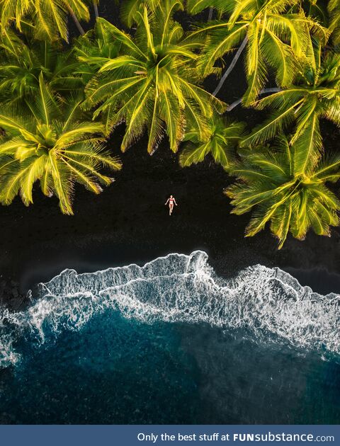 A black sand beach. Made from lava exploding as it cools from reaching the ocean