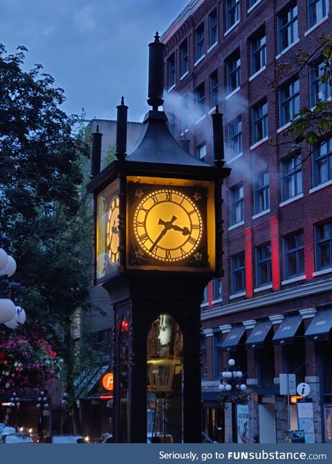 Clock powered by steam engine blowing steam