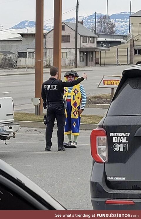 Cop giving a clown a road sobriety test