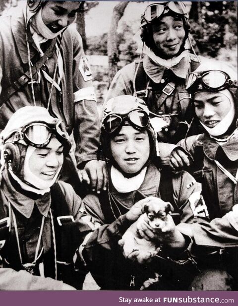 Japanese kamikaze pilots pose with a puppy before their final suicide mission in Okinawa,