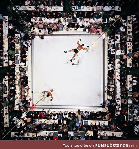 An overhead shot of Muhammad Ali celebrating a knockdown