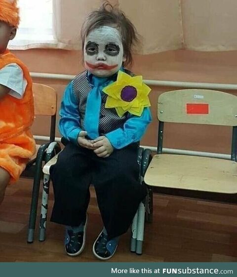 Boy dressed as the Joker looks sad